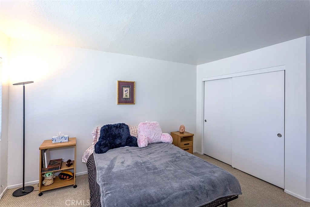 7065 9th Street, Unit 1 Buena Park, CA 90621 - Photo 21 of 36 a bedroom with a bed and a chair