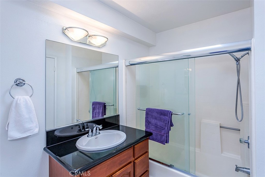 7065 9th Street, Unit 1 Buena Park, CA 90621 - Photo 22 of 36 a bathroom with a sink vanity tub and shower