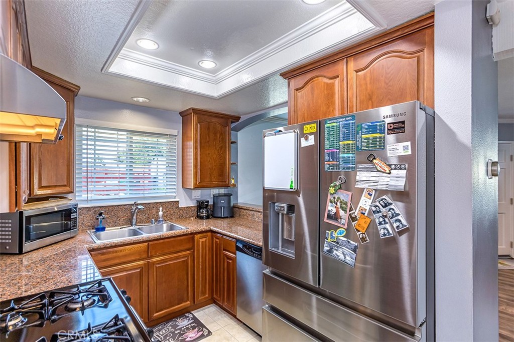 7065 9th Street, Unit 1 Buena Park, CA 90621 - Photo 10 of 36 a kitchen with stainless steel appliances granite countertop a refrigerator and a sink