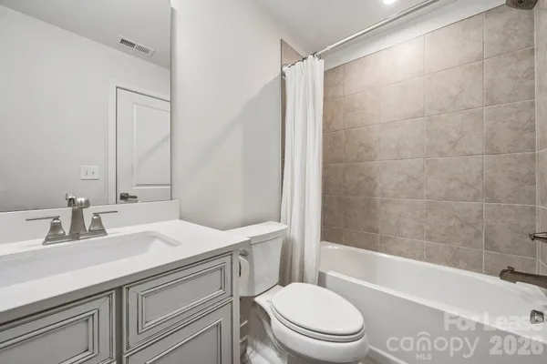a bathroom with a sink a toilet and a bathtub