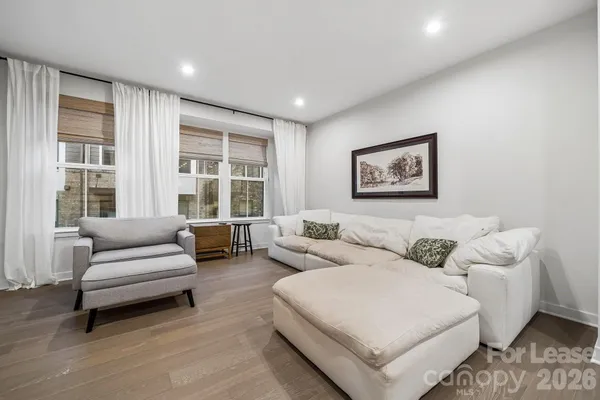 a living room with furniture and large windows