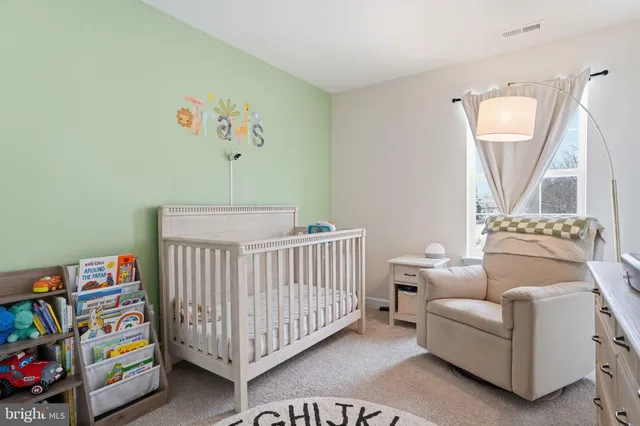 a bedroom with furniture and a baby crib