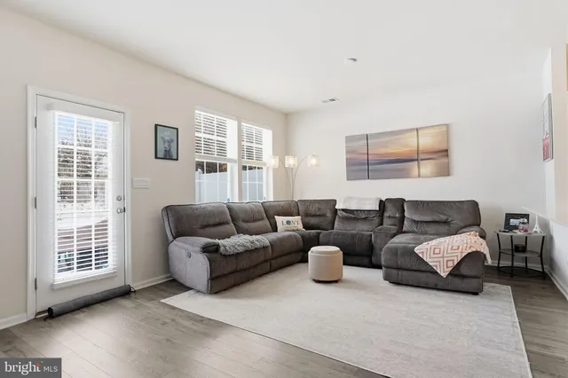 a living room with furniture and windows