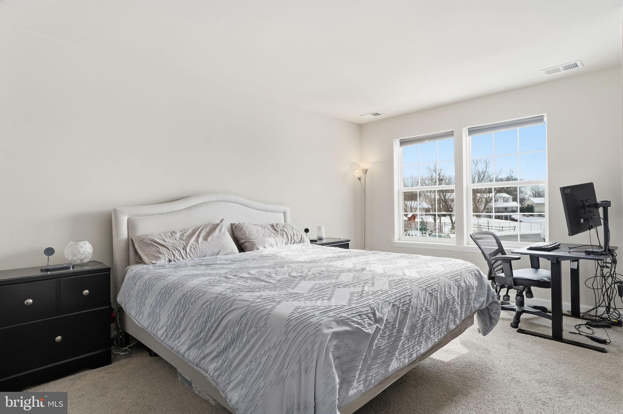 975 Still Waters Pennsburg, PA 18073 - Photo 9 of 20 Bright and airy primary bedroom with serene views.