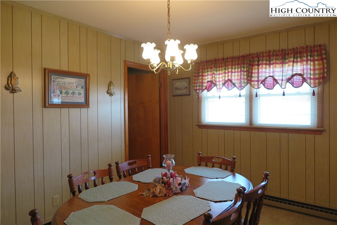 134 Carson Boulevard Sparta, NC 28675 - Photo 6 of 15 a view of a dining room with furniture a chandelier and a window
