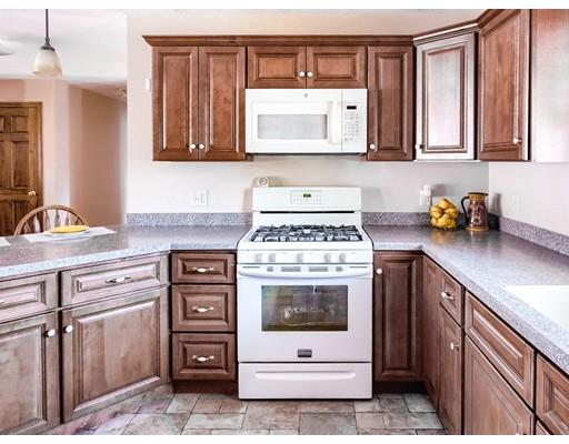 246 Pleasantdale Road Rutland, MA 01543 - Photo 11 of 29 a kitchen with stainless steel appliances granite countertop a stove microwave and cabinets