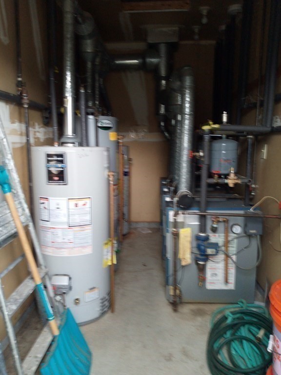 81 Mitchell Drive, Unit 81 Chicopee, MA 01022 - Photo 16 of 18 a kitchen with a refrigerator and a stove top oven