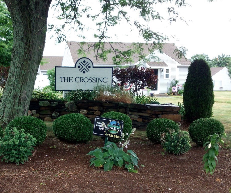 81 Mitchell Drive, Unit 81 Chicopee, MA 01022 - Photo 2 of 18 a sign that is sitting in front of flowers