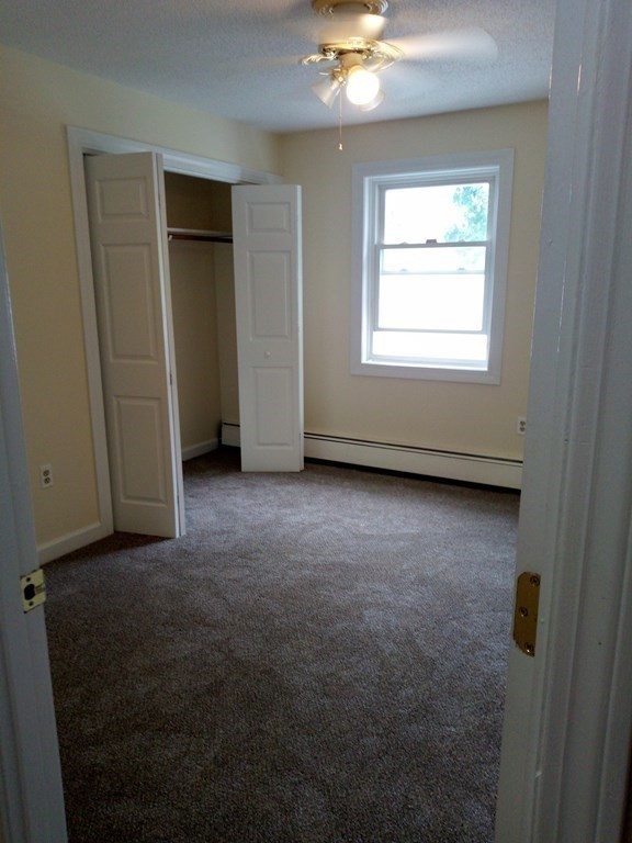 81 Mitchell Drive, Unit 81 Chicopee, MA 01022 - Photo 7 of 18 an empty room with windows and closet