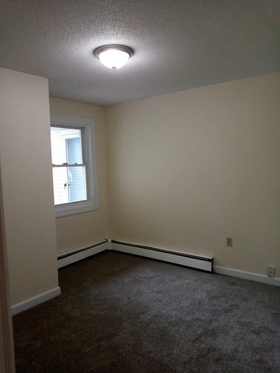81 Mitchell Drive, Unit 81 Chicopee, MA 01022 - Photo 9 of 18 an empty room with a window