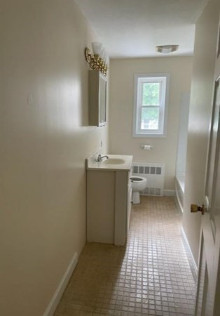 81 Mitchell Drive, Unit 81 Chicopee, MA 01022 - Photo 10 of 18 a bathroom with a sink a toilet and mirror