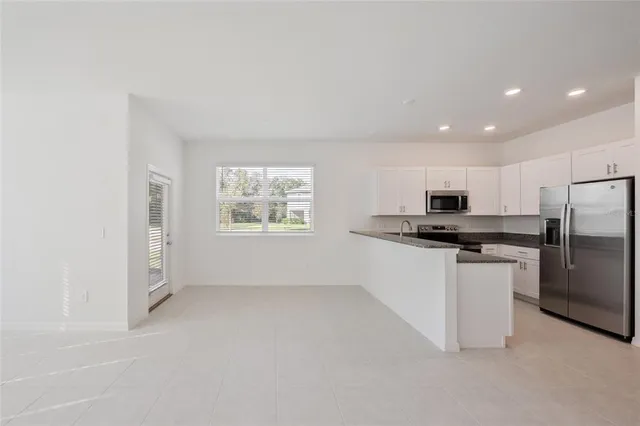 a kitchen with refrigerator and window