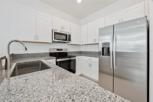 a kitchen with a refrigerator stove and sink