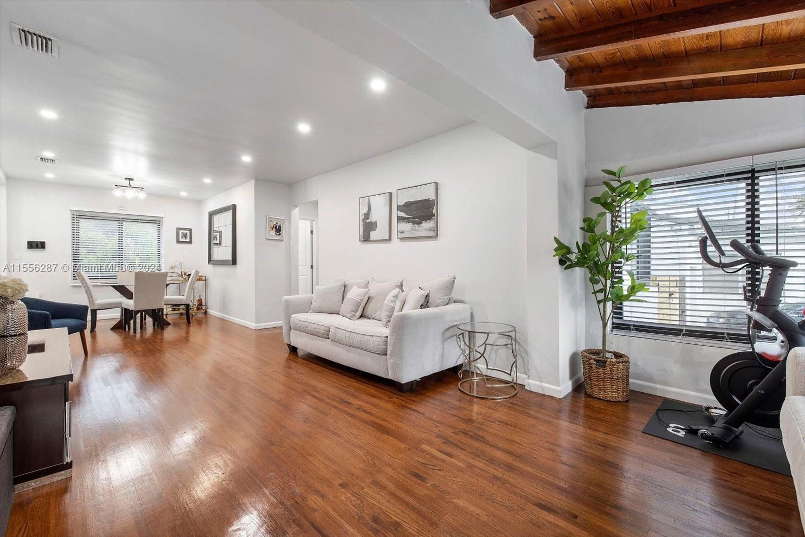 4631 Southwest 12th Street Miami, FL 33134 - Photo 1 of 28 a living room with furniture and a table