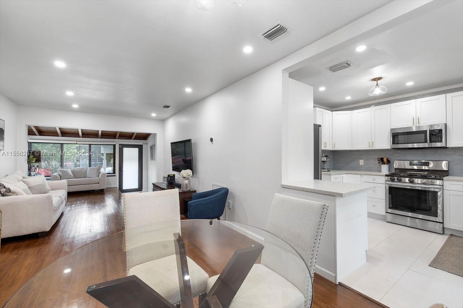 4631 Southwest 12th Street Miami, FL 33134 - Photo 11 of 28 a living room with stainless steel appliances furniture or couch and a kitchen