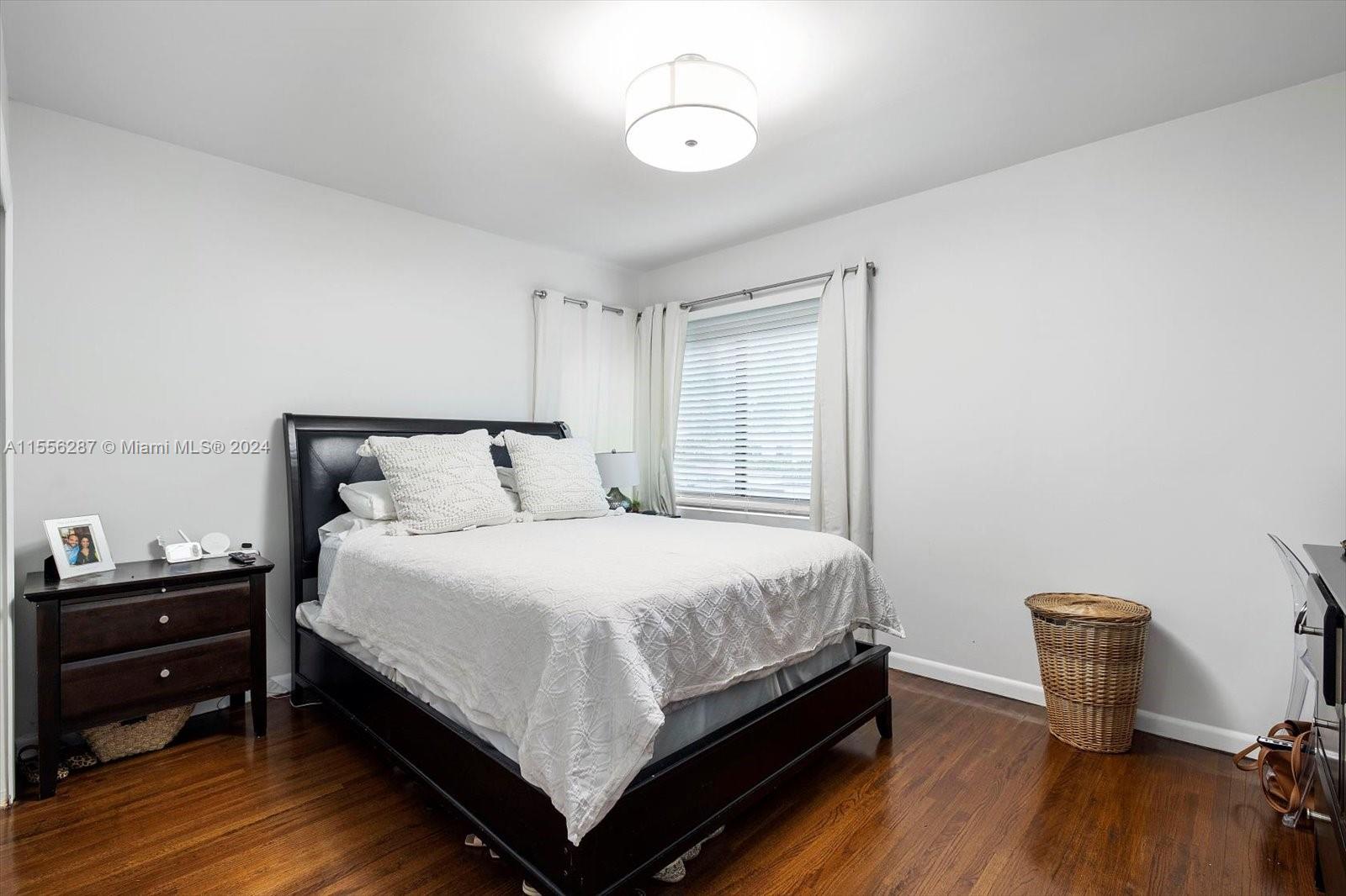 4631 Southwest 12th Street Miami, FL 33134 - Photo 18 of 28 a bedroom with a bed and wooden floor