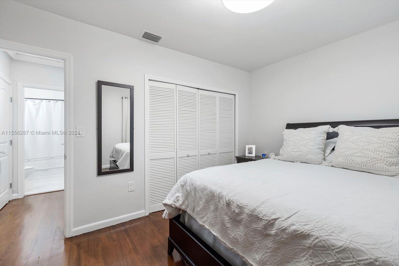 4631 Southwest 12th Street Miami, FL 33134 - Photo 19 of 28 a bedroom with a bed and wooden floor