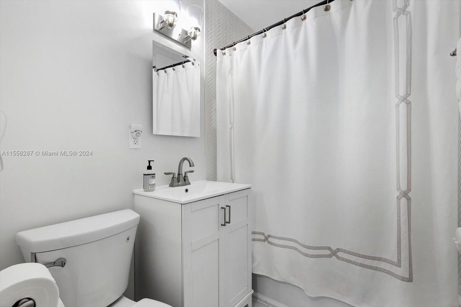 4631 Southwest 12th Street Miami, FL 33134 - Photo 21 of 28 a view of a bathroom with a sink and a toilet