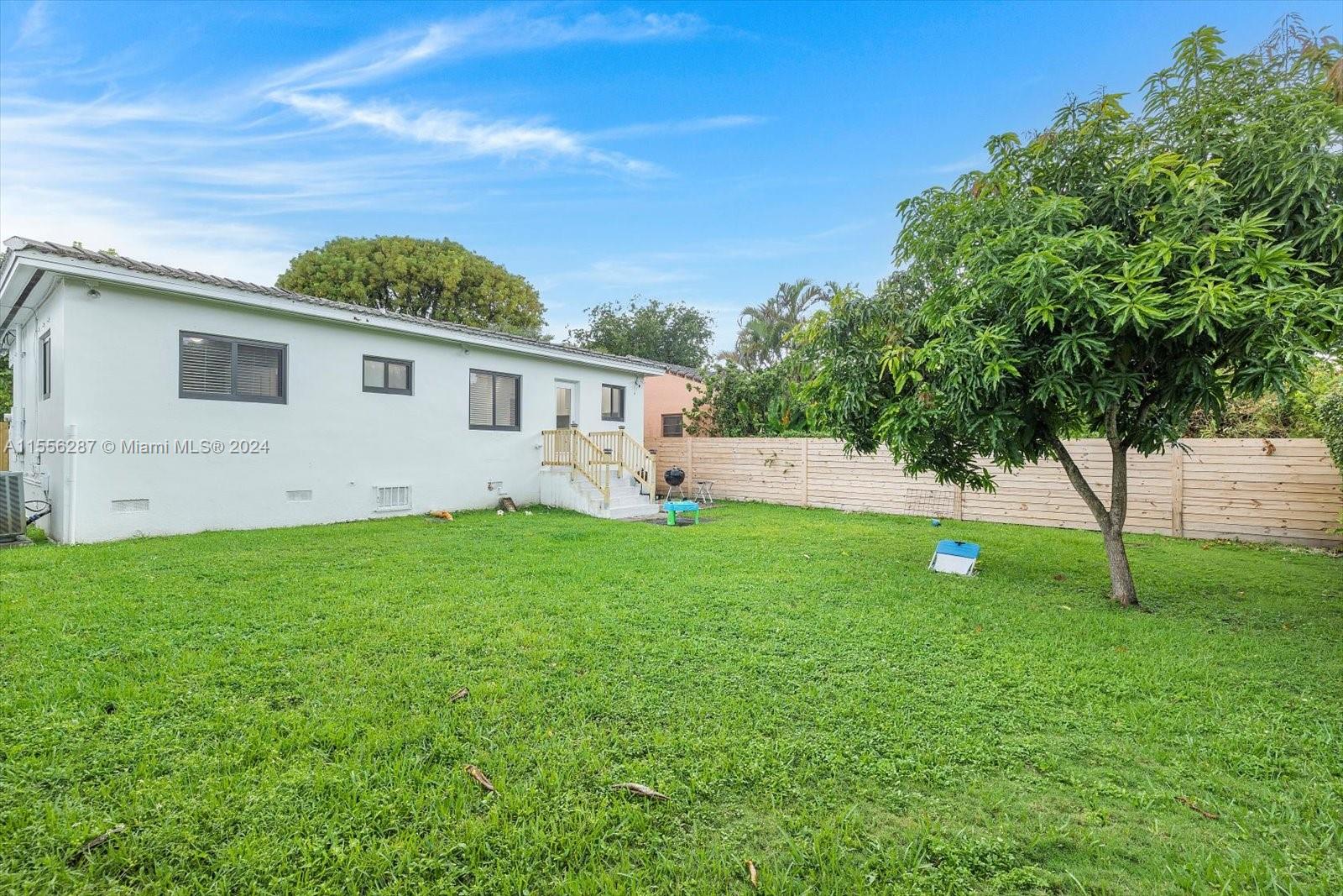 4631 Southwest 12th Street Miami, FL 33134 - Photo 28 of 28 a view of a backyard with plants and large trees