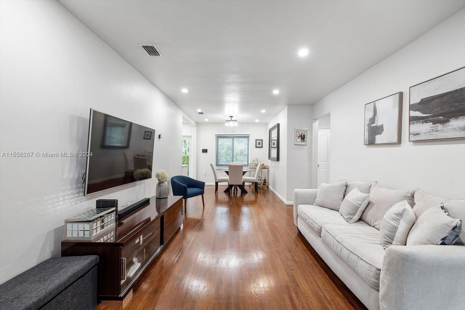 4631 Southwest 12th Street Miami, FL 33134 - Photo 3 of 28 a living room with furniture and a flat screen tv