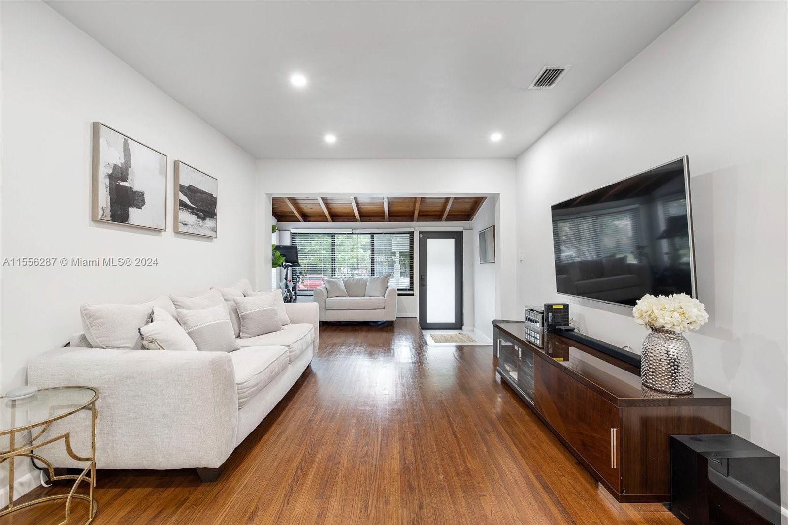 4631 Southwest 12th Street Miami, FL 33134 - Photo 5 of 28 a living room with furniture and wooden floor