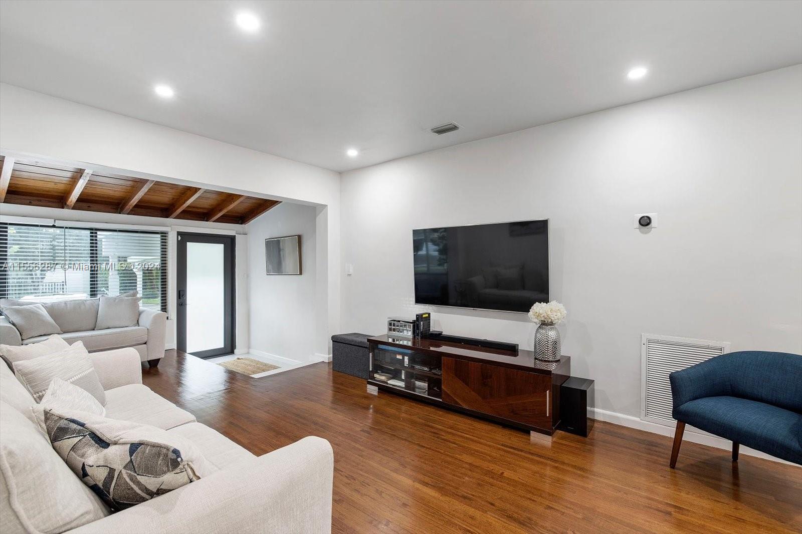 4631 Southwest 12th Street Miami, FL 33134 - Photo 8 of 28 a living room with furniture and a flat screen tv