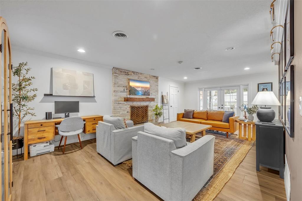 180 Spring Lake Hills Drive Altamonte Springs, FL 32714 - Photo 18 of 67 a living room with fireplace furniture and a wooden floor