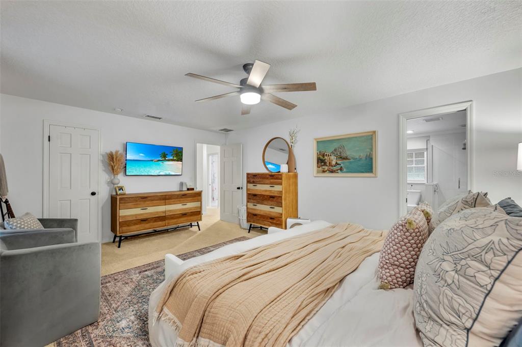 180 Spring Lake Hills Drive Altamonte Springs, FL 32714 - Photo 28 of 67 a bedroom with a bed and a chandelier