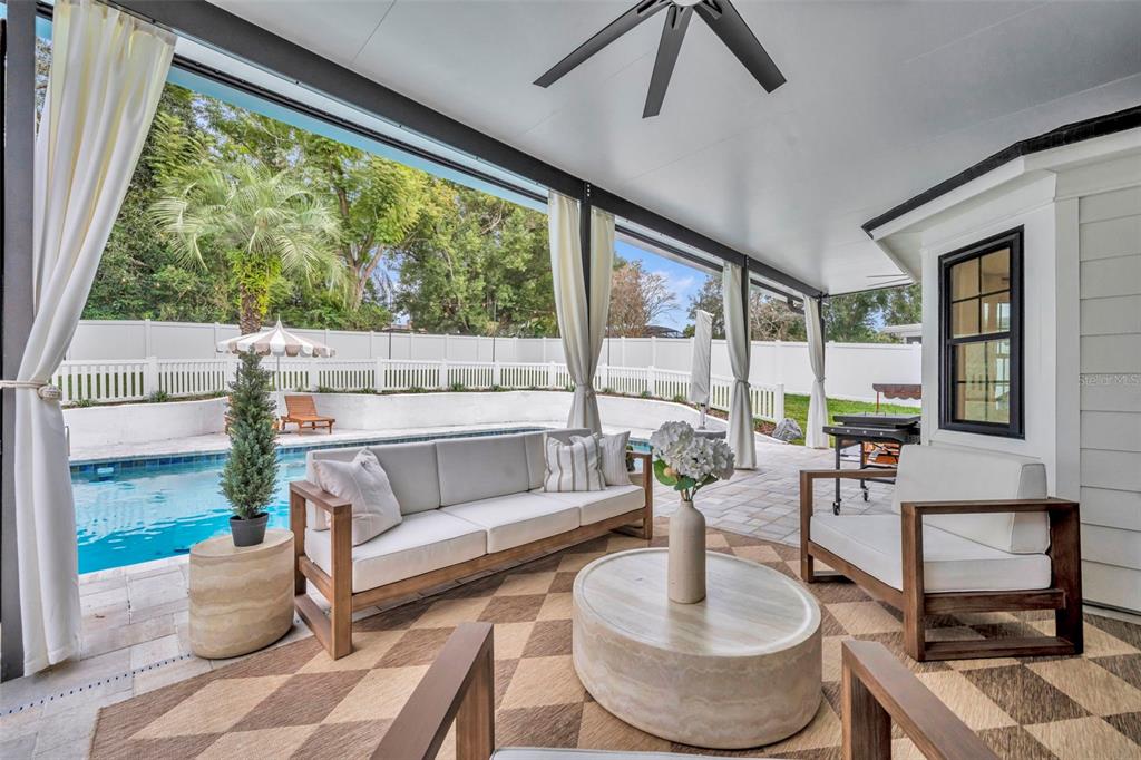 180 Spring Lake Hills Drive Altamonte Springs, FL 32714 - Photo 38 of 67 a living room with patio furniture and a large window