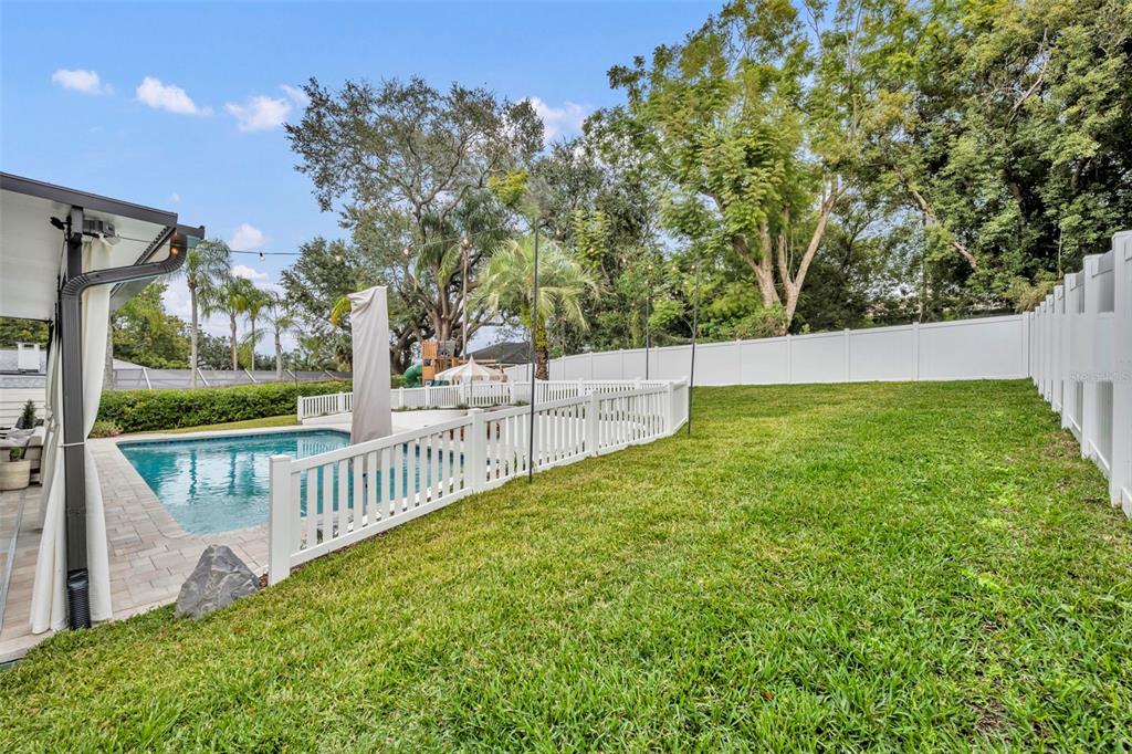 180 Spring Lake Hills Drive Altamonte Springs, FL 32714 - Photo 49 of 67 a view of a yard with wooden fence