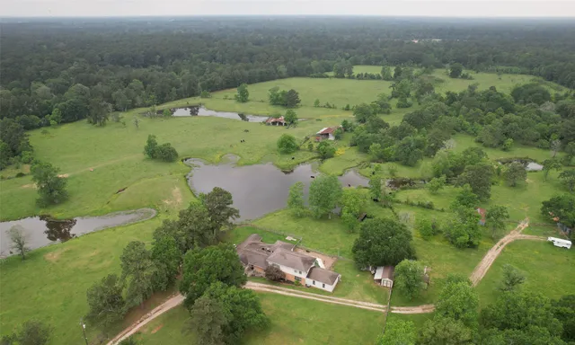 an aerial view of a house with a yard