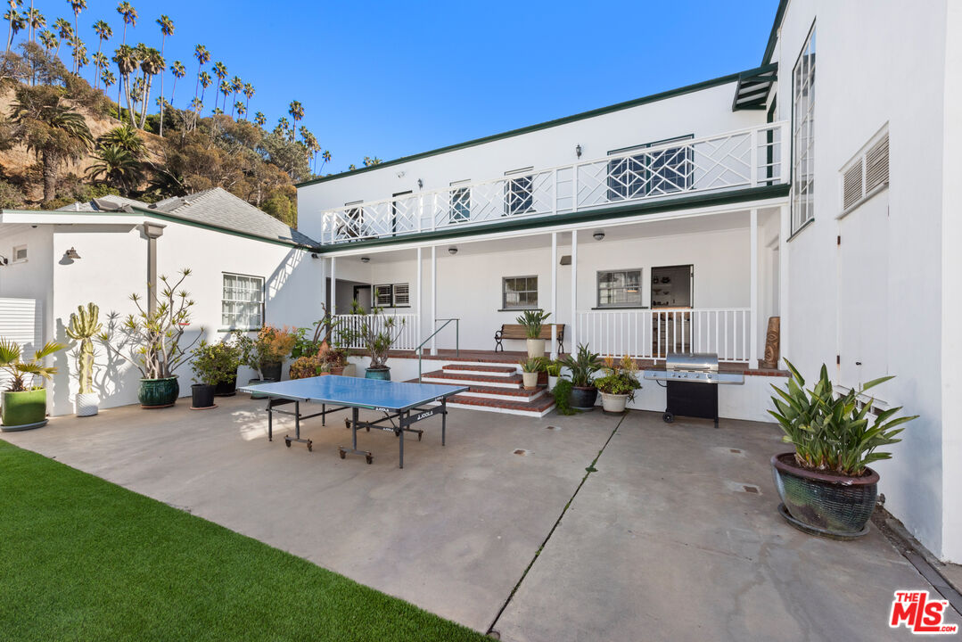 605 Palisades Beach Road Santa Monica, CA 90402 - Photo 10 of 33 a view of a patio with table and chairs and potted plants