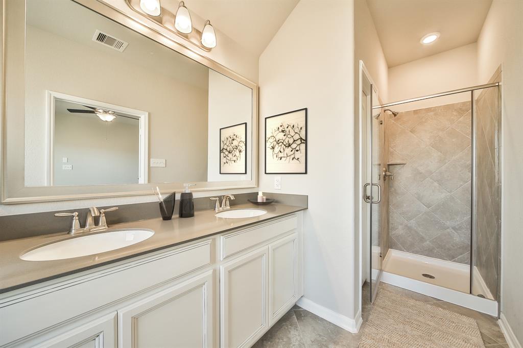 a bathroom with a granite countertop sink mirror and double