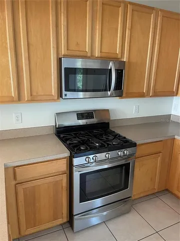 a kitchen with granite countertop white cabinets and stainless steel appliances