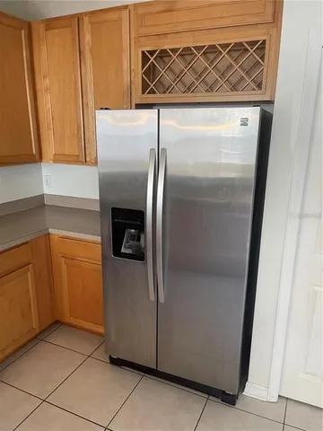 a metallic refrigerator freezer sitting in a kitchen