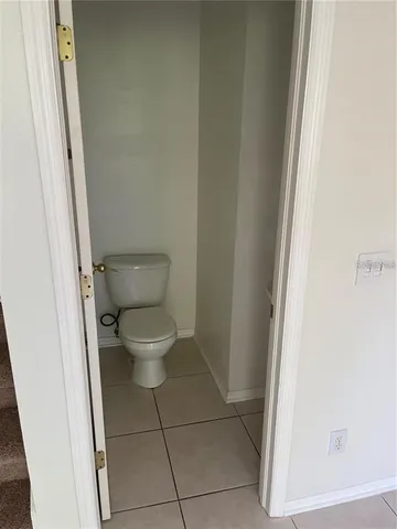 a white toilet sitting next to a shower