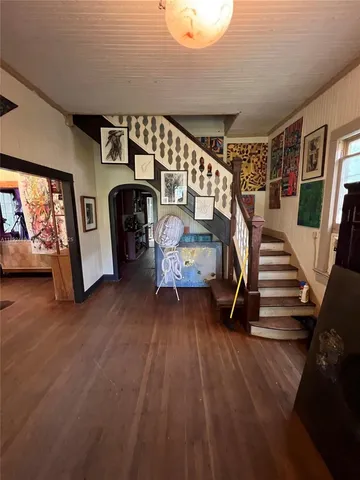 a view of entryway and hall with wooden floor