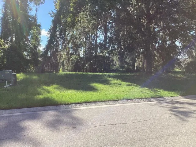 a kitchen with stainless steel appliances kitchen island granite countertop a table chairs and a refrigerator