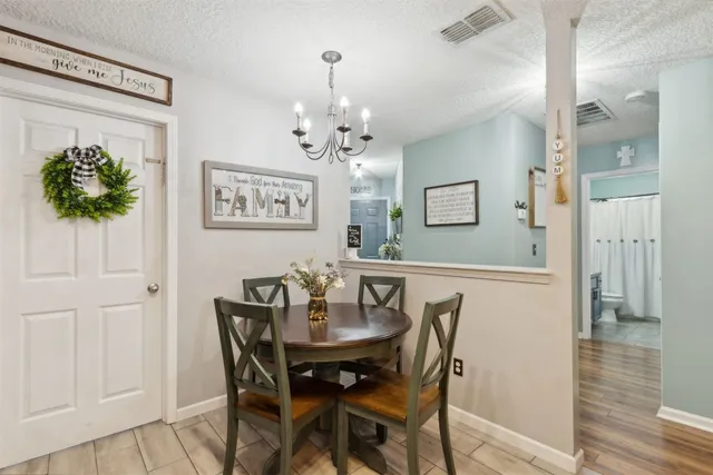 a bedroom with a bed dresser and a flat screen tv