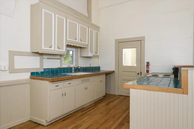 a kitchen with granite countertop a sink and cabinets