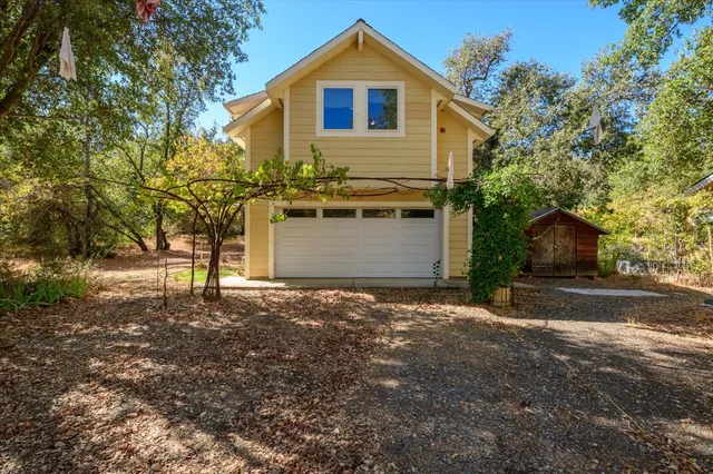 a view of backyard of house with green space