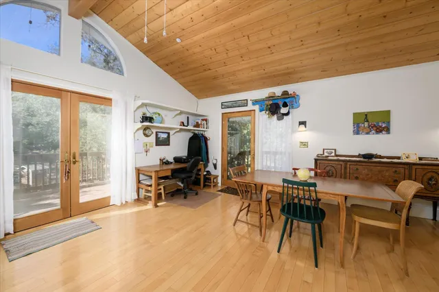 a living room with furniture a flat screen tv and floor to ceiling window