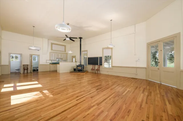 a view of a living room and kitchen with wooden floor