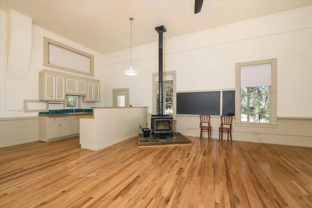 a living room with a flat screen tv with kitchen view