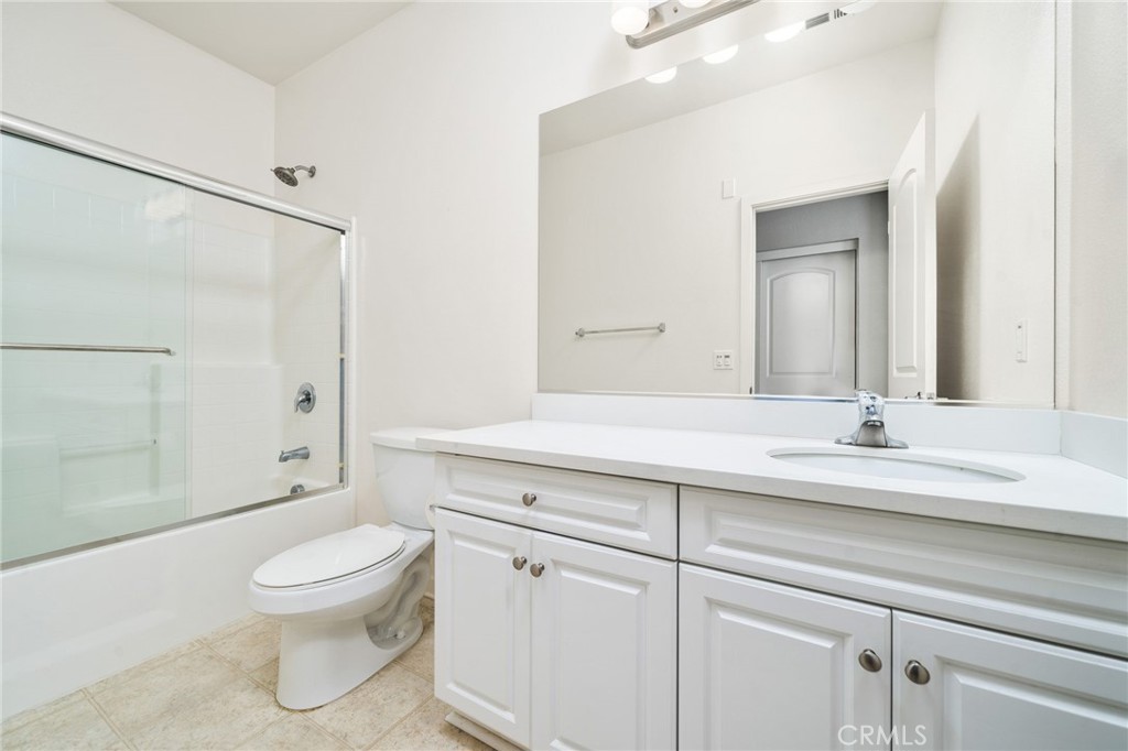 8836 Jacaranda Avenue, Unit D Montclair, CA 91763 - Photo 12 of 26 a bathroom with a toilet a sink and shower