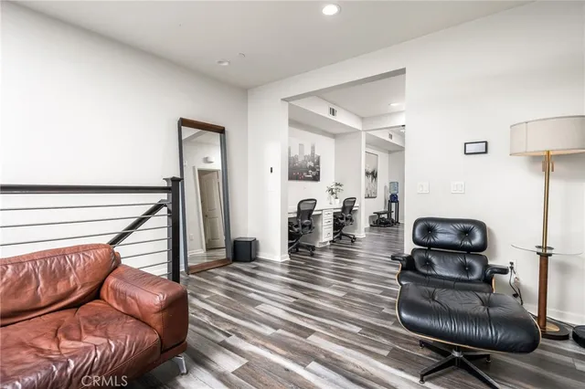 a hallway with a couch and a wooden floor