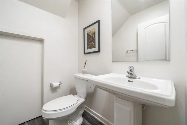 a bathroom with a sink mirror and toilet