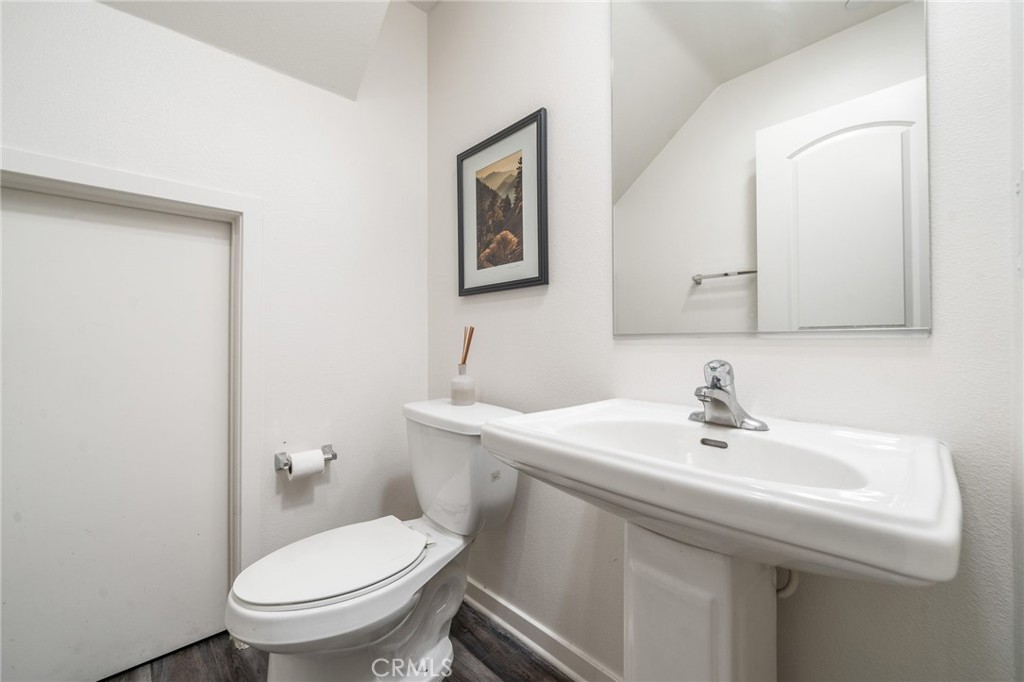 8836 Jacaranda Avenue, Unit D Montclair, CA 91763 - Photo 9 of 26 a bathroom with a sink mirror and toilet