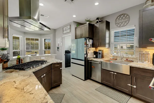 a kitchen with a sink stove and refrigerator