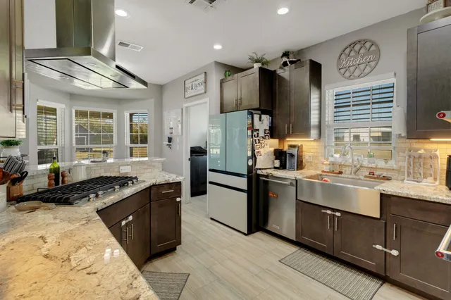 a kitchen with a sink stove and refrigerator